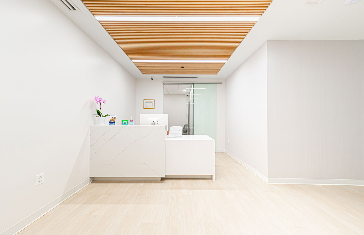 Project Dental Dental Reception Area 31437 Modern reception desk at Project Dental in Rockville, MD with wooden ceiling panels